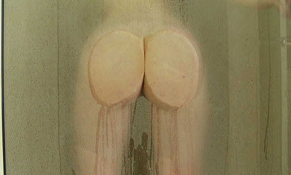 Dakota Charms presses her ass cheeks against a glass door